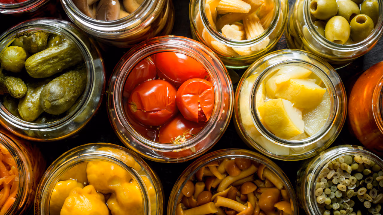 Jars of preserved vegetables — pickles, tomatoes, olives, mushrooms